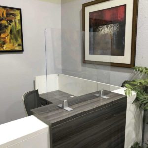 acrylic panel with standalone clamps on reception desk